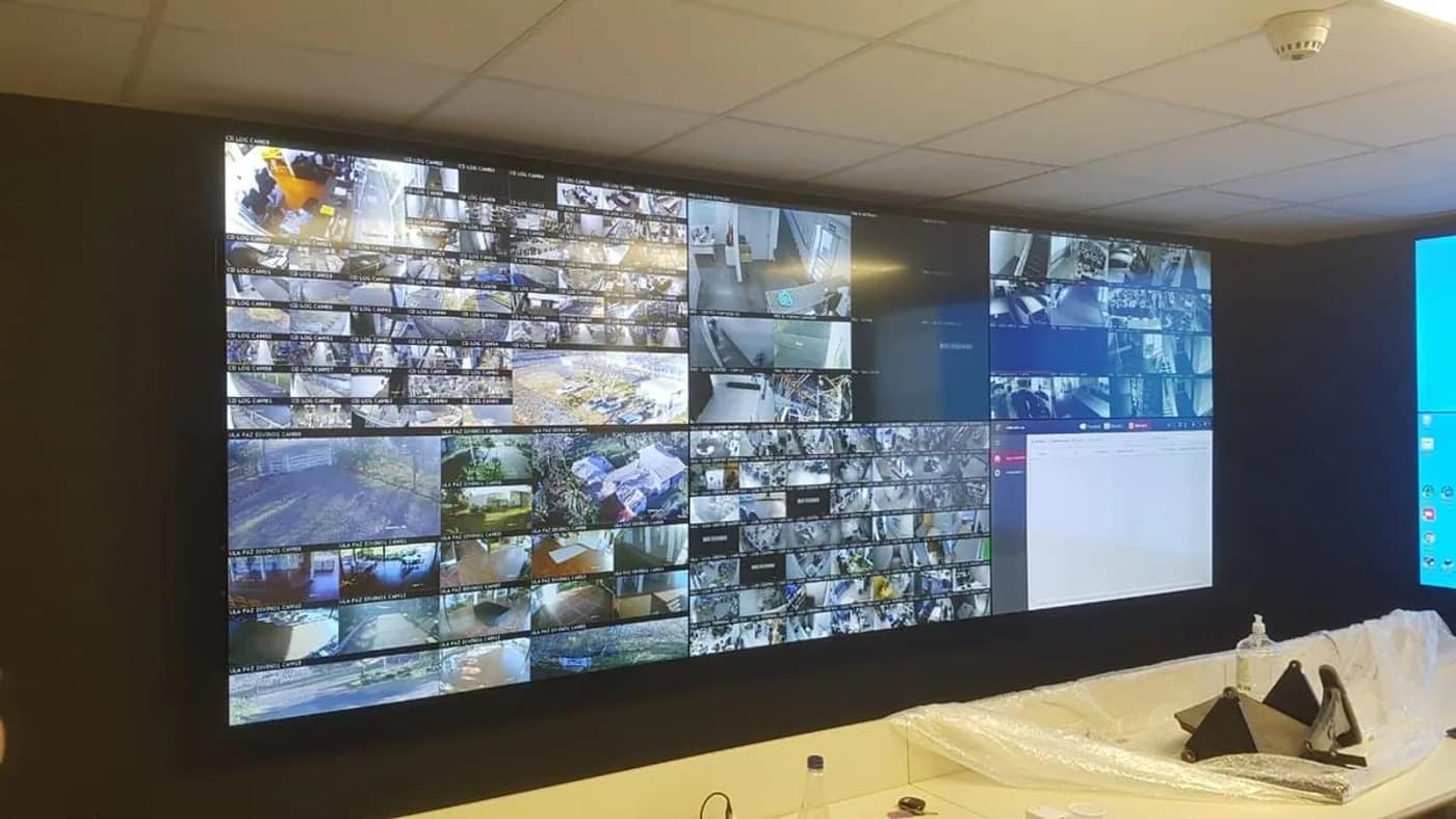 Parede de monitores em operação, exibindo imagens de câmeras.